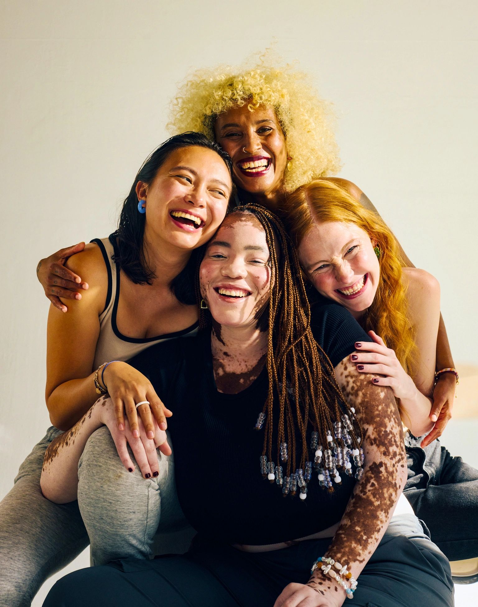 Diverse women smiling together in a bright, premium lifestyle portrait